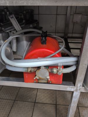 a red fire hydrant with a hose attached to it