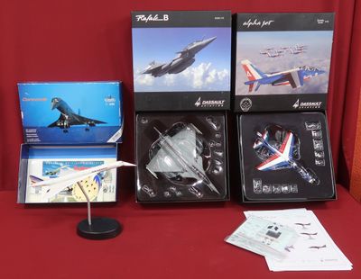 a lot of model airplanes sitting on a red table