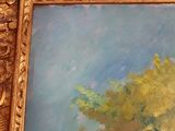 an oil painting of a tree in a golden frame on a wall