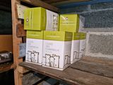 many boxes of wine sitting on a shelf in a room