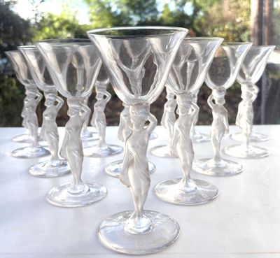 six wine glasses sitting on a table outside