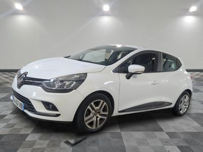 a white car is parked in a room with a checkered floor