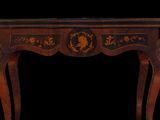 an image of a small table with a black and gold decoration