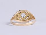 a close up of a gold ring with a diamond in the center