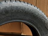a close up of a tire on a cardboard box with a cardboard box in the background