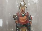 a plastic container with a figurine of a man sitting on a cat