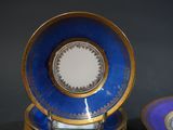 three blue and gold plates sitting on top of each other