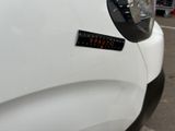 a close up of a white car with a sticker on it