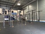 a gym area with a pull up bar in the middle of the room