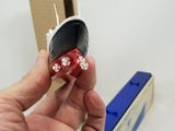 a person holding a red and white dice in their hand