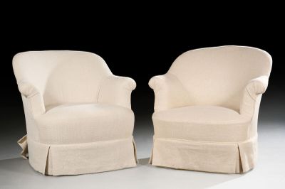 pair of cream upholstered chairs with pleaed seats