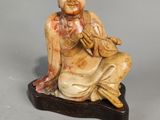 a small statue of a person sitting on a table