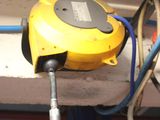 a yellow machine that is connected to a blue hose