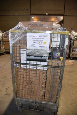 a metal cart with a sign on it in a warehouse