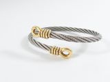 a close up of two cable bracelets on a white surface