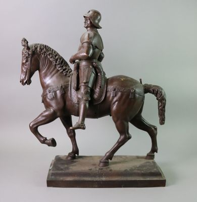a bronze statue of a man riding a horse