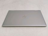 the back of a laptop computer sitting on top of a white surface