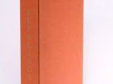 a book with a red cover sitting on top of a white surface