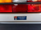 a close up of a white car with a sticker on the back of it