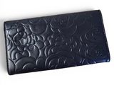 black leather wallet with a mickey mouse design on the front