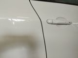 a close up of a car door handle with a hole in it