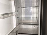 an open refrigerator that is sitting in a room