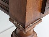 a close up of a wooden table with a drawer on it
