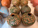 many different colored vases sitting on a table