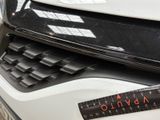 a close up of a car ' s grille with a ruler on it