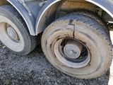 a truck that has a flat tire on the side of the road