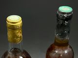 two bottles of alcohol sitting next to each other on a table