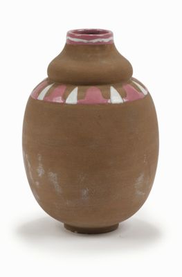 a brown vase with a pink and white design on it