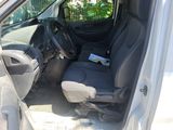the interior of a car with the door open and the driver ' s seat down