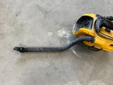 a yellow and black vacuum sitting on the floor