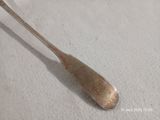 une cuillère posée sur une surface blanche
