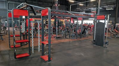 a gym with a lot of equipment in the room