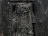 a stone carving of a face on the side of a building