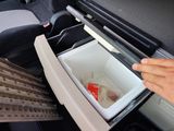 a person opening a cooler in the back of a car