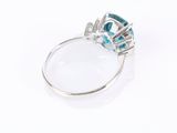 a close up of a ring on a white surface with a magnifying glass