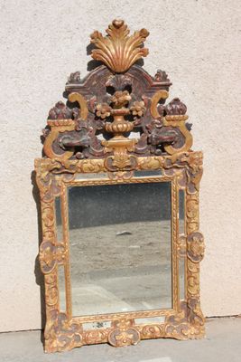 a mirror that is sitting on the ground next to a wall