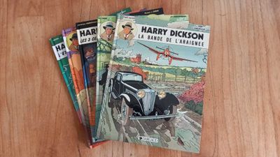 three books on a wooden table, one of which is a car and the other of which is a plane