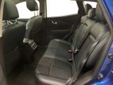 the back seats of a blue car with a black seat belt