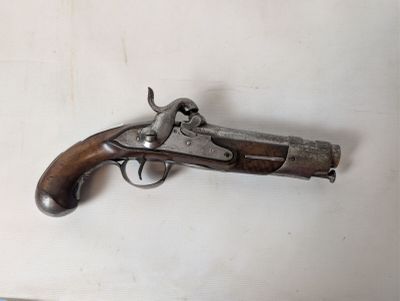 an old gun that is on a white surface