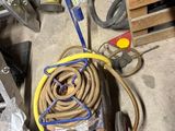a hose that is sitting on a cart in the garage