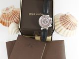 louis vuitton watch in a box next to shells and seashells