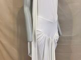 the mannequin is wearing a white dress with a long cape over it
