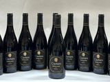 six bottles of wine are lined up in a row on a table