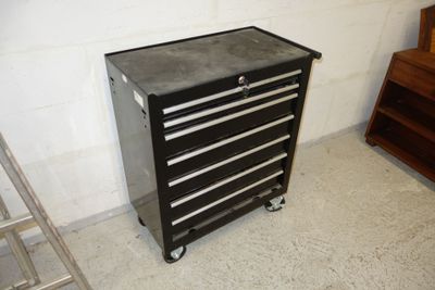 a black tool cabinet sitting in the corner of a room