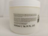 a close up of a jar of cream on a white surface