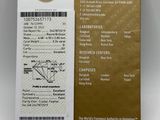 a close up of a gold and white boarding card with a picture of a plane on it